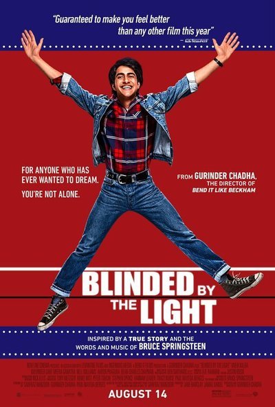 Promotional poster for Blinded by the Light, featuring a young South Asian man jumping with arms and legs outstretched across a red and blue background.